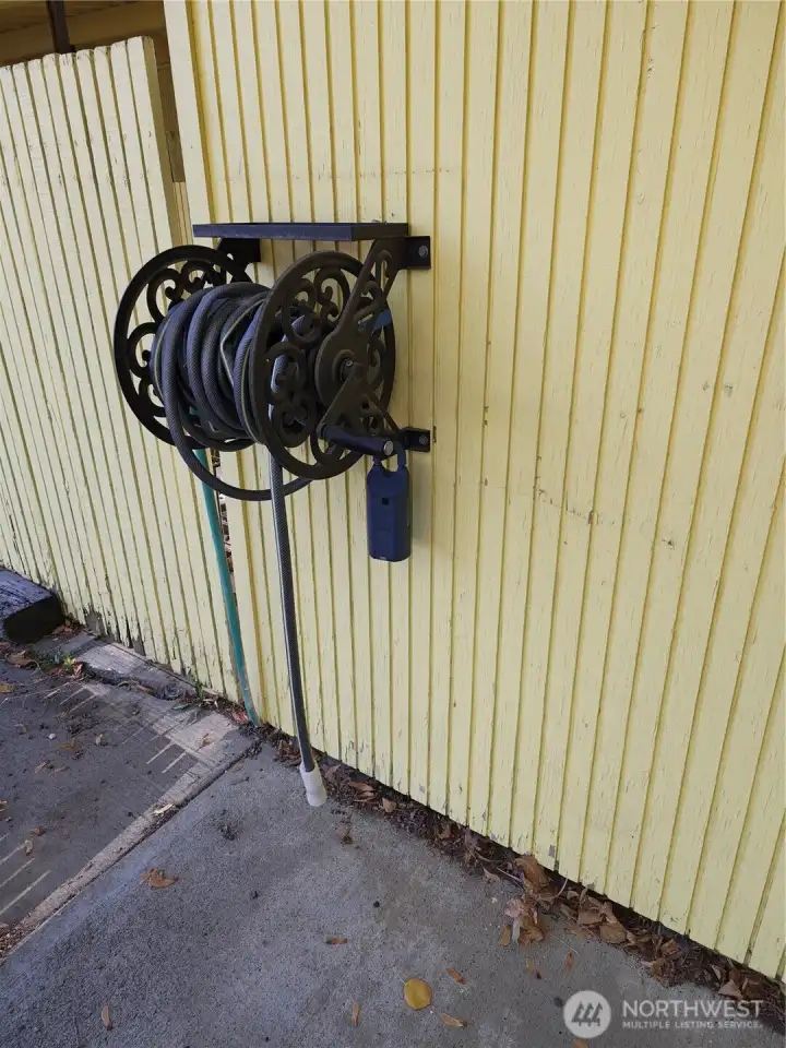 Key box is on water hose on front of Unit 205