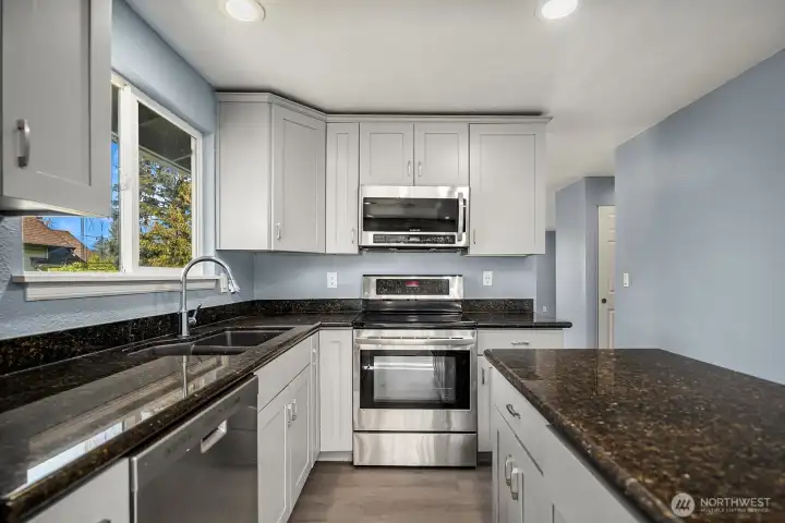 Open and functional kitchen layout with center island, modern fixtures, and plenty of prep and storage space.