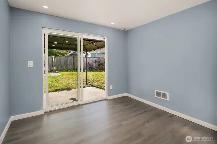 Bright and open room with sliding glass doors leading to the backyard, perfect for indoor-outdoor entertaining.