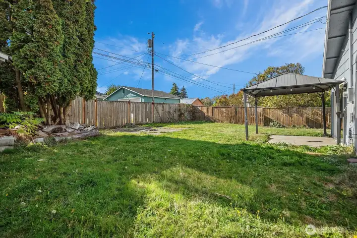 Expansive fenced yard with level lawn and ample space for outdoor living or future garden projects.