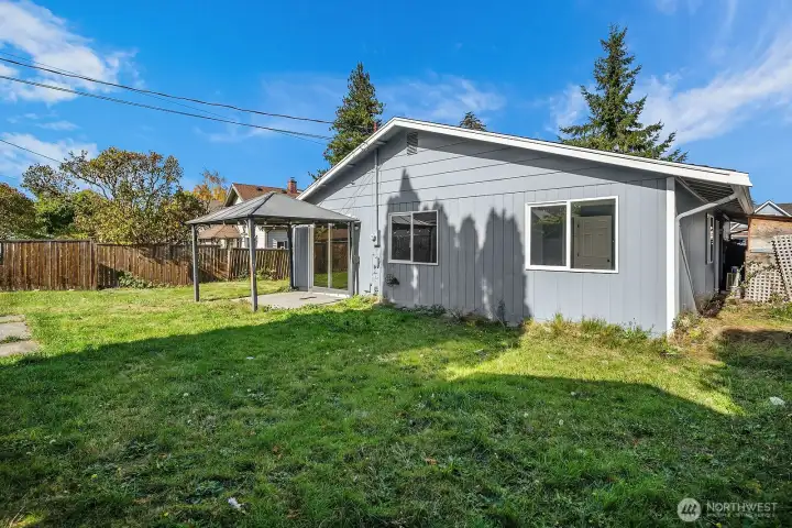 Concrete patio with sturdy metal gazebo—perfect for barbecues, entertaining, or relaxing in the shade.