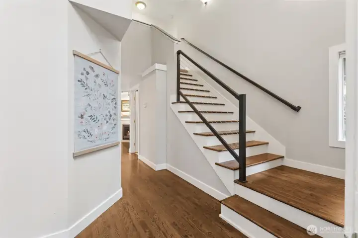 As you enter the home, you will find this dramatic 2-story entry with legit hardwood floors and staircase with modern touches.