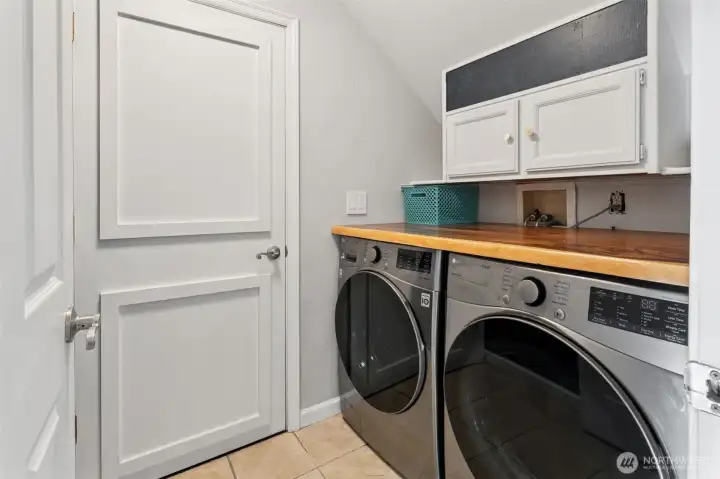 Utility room view, door leads to your garage, love the storage and folding shelf!