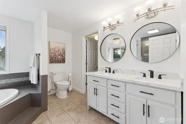 Primary ensuite bath view one, I LOVE the soaking tub, walk-in closet, and classy double vanity. Updated fixtures as well!