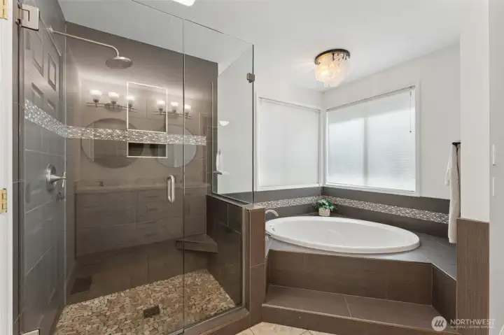 Primary ensuite bath view two showing separate soaking tub and walk-in shower with handy seat! An OASIS.