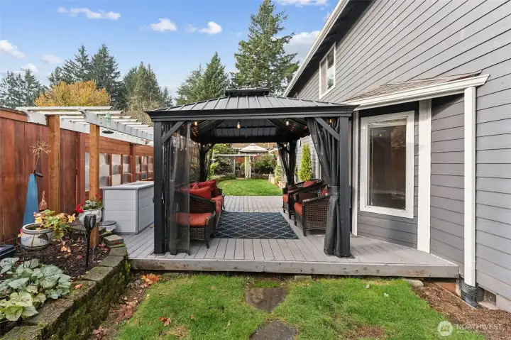 As you walk out the back of your home off of the family room, you will find an amazing space for relaxing and entertaining. Large covered deck with included gazebo, Costco lights & deck box, plus so much more!