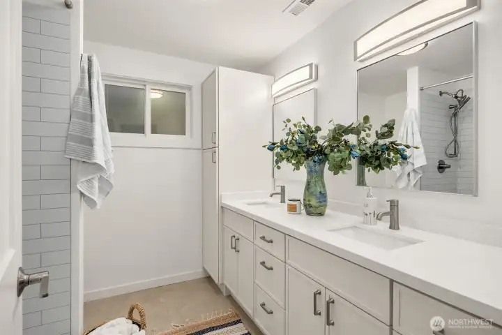 Freshly renovated and refreshed, the 2nd floor bathroom's double vanity offers plenty of space and storage.