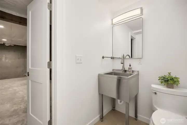 The basement offers a renovated 1/2 bath with a practical utility sink.