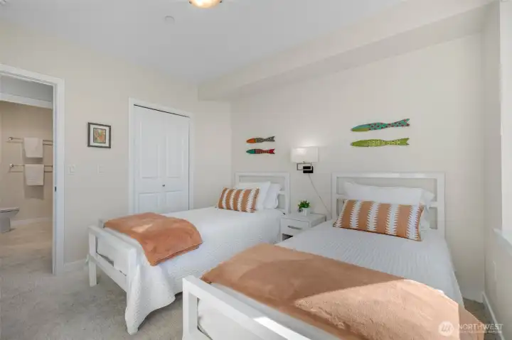 Private second bedroom with a walk-in closet and an adjacent full bathroom.