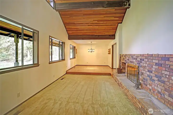 Upon entry, this captures the formal living room with huge wood burling fireplace and formal dining room.