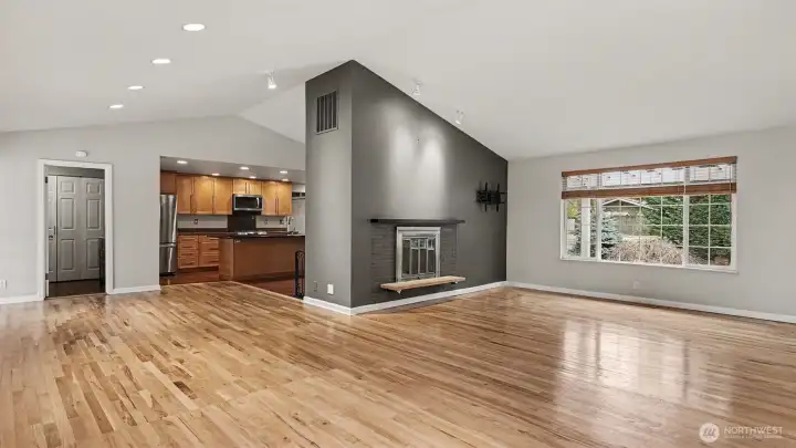Spacious living room with cozy wood burning fireplace.