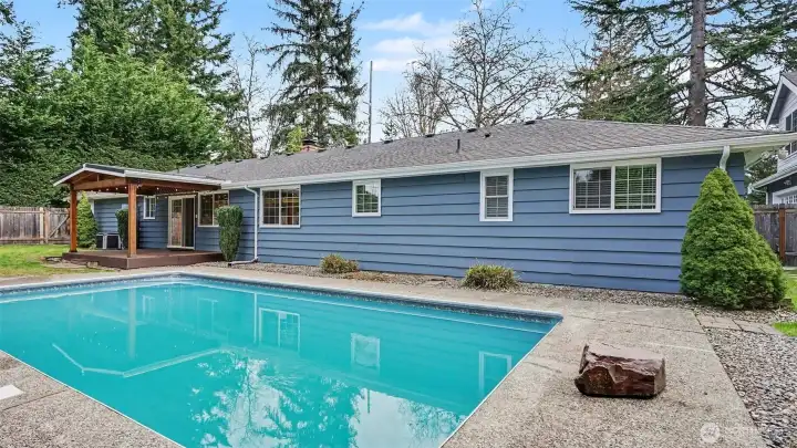 Cozy covered back porch features outdoor ceiling fan for year around enjoyment.