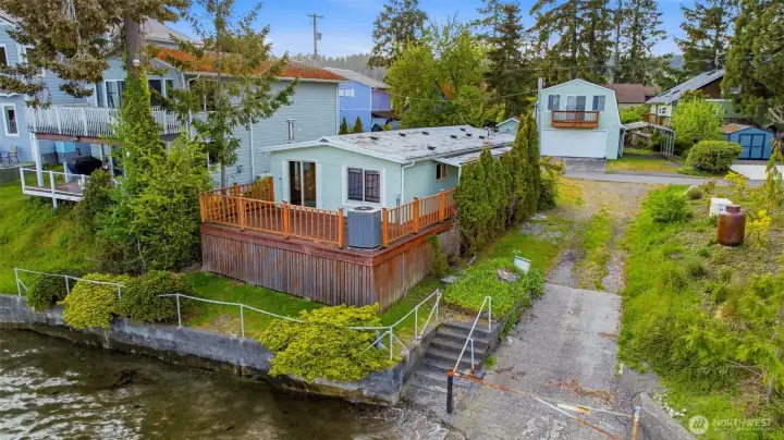 This is a two-parcel sale including the manufactured home, a detached two story, two car garage with storage space above and side yard carport.