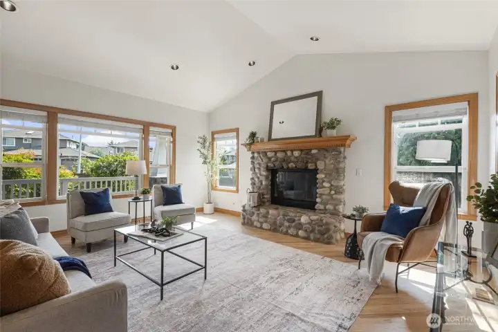 Beautiful river rock fireplace adds warmth, texture, and timeless Pacific Northwest character to the spacious living room.