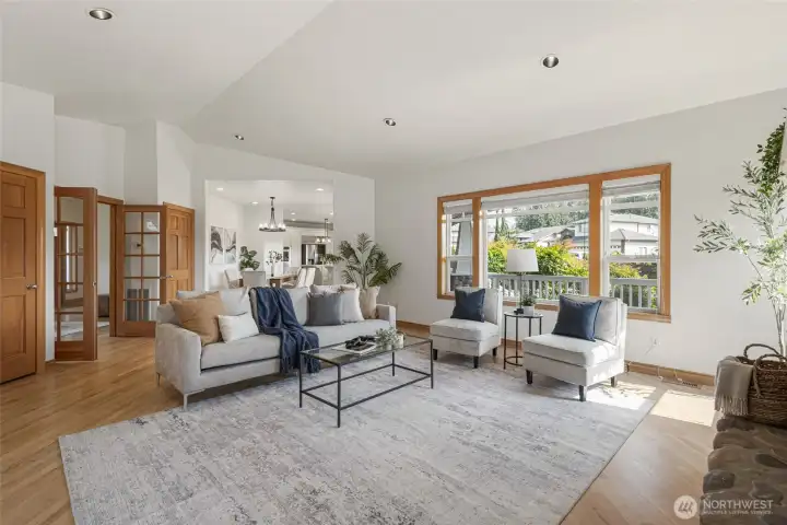 Warm wood-wrapped windows, vaulted ceilings, and timeless Craftsman architecture create an inviting living space filled with natural light and elegant Northwest charm.