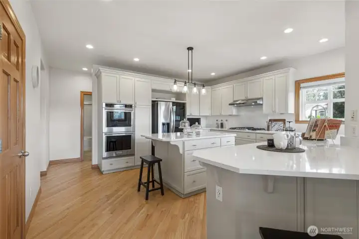 Gather in the heart of the home where expansive quartz counters, abundant cabinetry, and the open kitchen layout create the perfect space for morning coffee, casual meals, and entertaining guests.