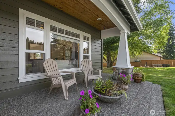 Covered front porch, warm and inviting, offers a welcoming space.