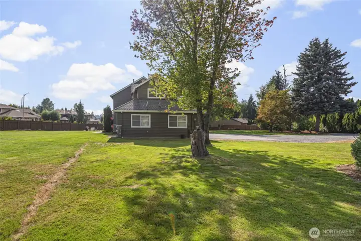 Rare usable acreage offers endless possibilities with expansive lawn space, mature trees, privacy, and a peaceful estate-like setting just minutes from Mill Creek amenities.