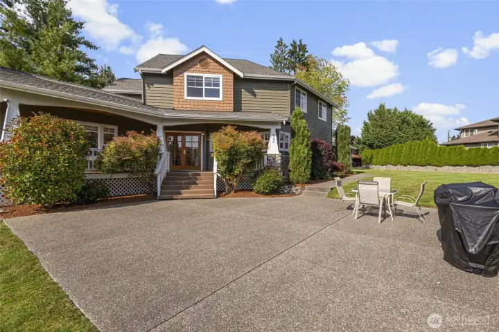 The property features a covered deck area providing shelter and a spacious patio ideal for outdoor gatherings and relaxation.