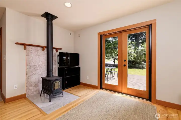 Small efficient wood stove and French Doors with custom hide a way screen doors.