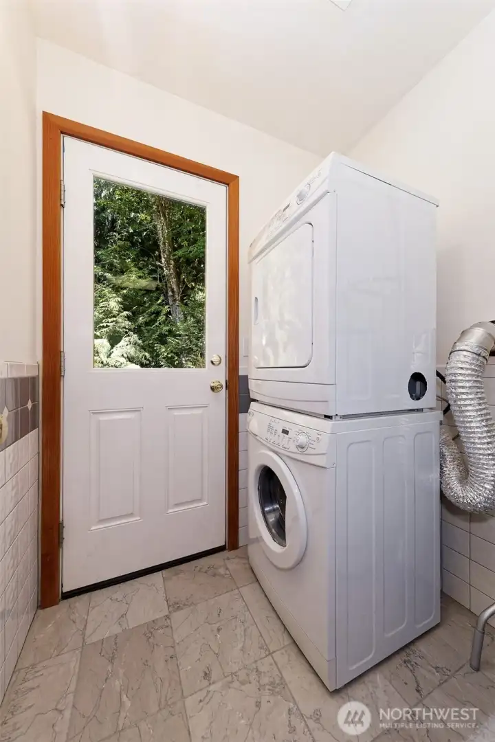 separate laundry room with back door and back parch leading to the creek.