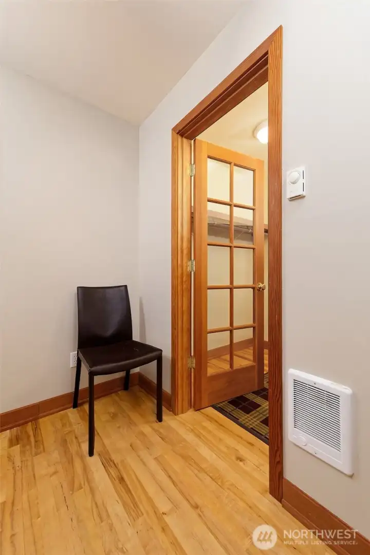 Custom interior doors with glass panels featured throughout this home. This one leads from the bedroom into the walk in closet.