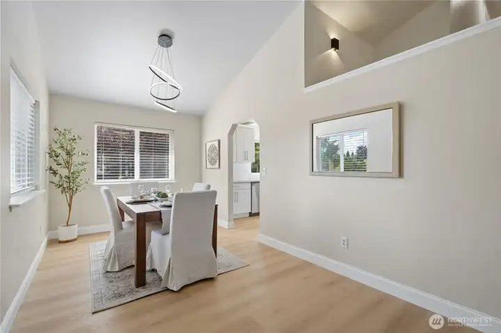Perfect for everyday living or entertaining, the dining room features soaring ceilings, large picture windows and a stylish new light fixture.