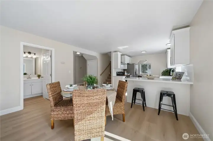 A breakfast bar offers the perfect spot for homework, conversation or an extra set of helping hands in the kitchen. The remodeled half bath is just through the door to the left.
