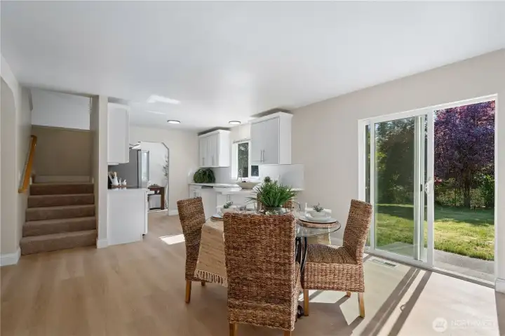 Step through the sliding doors to a spacious patio and a sprawling, fully fenced backyard.