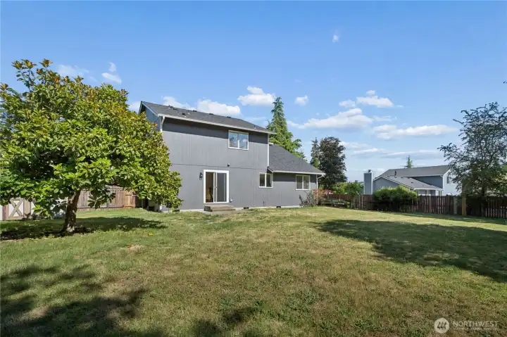 The expansive backyard is a blank canvas with endless possibilities for pets, play, gardening or entertaining.