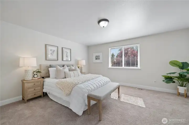The expansive primary suite feels both inviting and serene, while brand-new plush carpeting throughout the upstairs adds warmth and comfort.