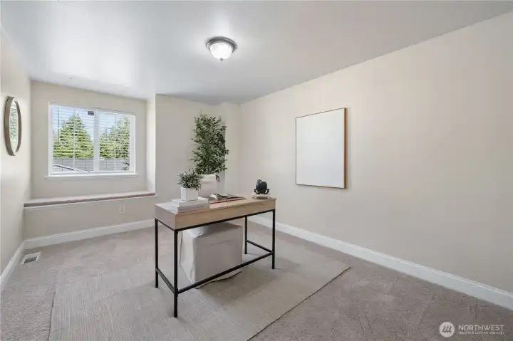 The second spacious bedroom features a charming window seat, a large picture window and a generously sized closet.