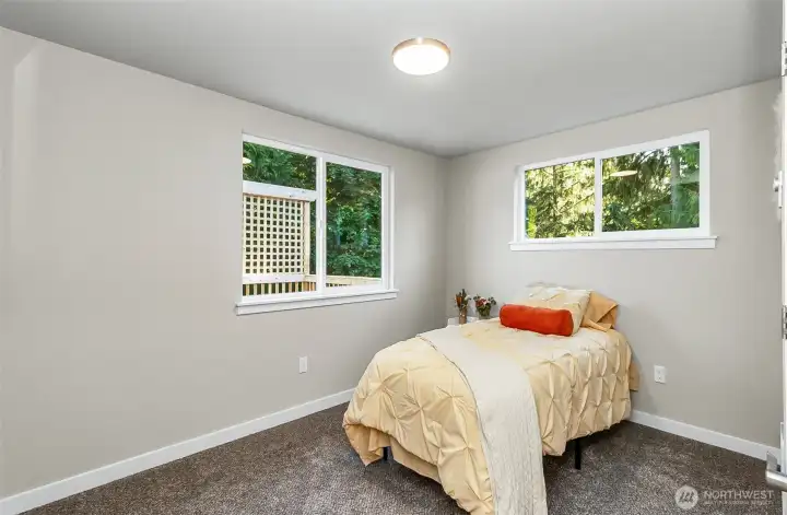 Bedroom #2 upstairs~ view of the deck and surrounding trees~