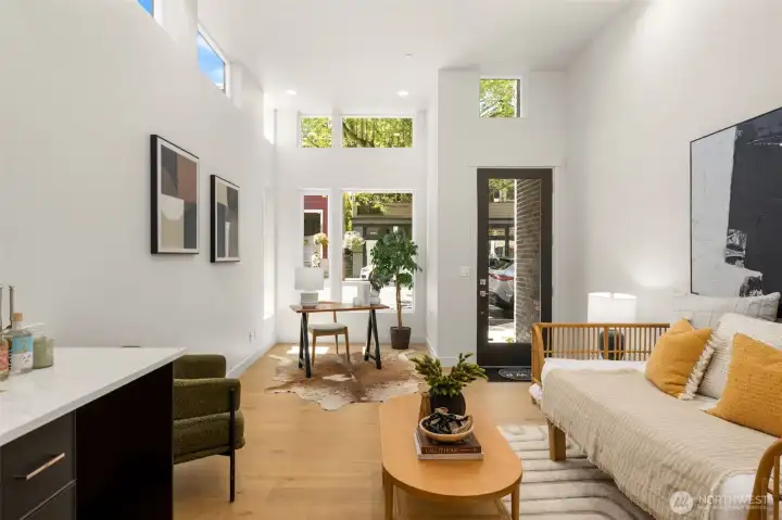 A versatile live-work space on the ground floor is perfectly designed for either commercial or residential use, offering a bright and spacious environment that adapts to your unique vision.  Slot 3: "Flexibility at its finest: work from home, open up a storefront, or simply enjoy a spacious second living room.(photos are of model home, similar finishes and floorplan)