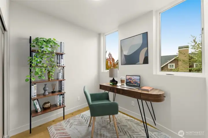 A modern home office or guest room features clean lines and a large window that captures the soft glow of long summer evenings.(photos are of model home, similar finishes and floorplan)
