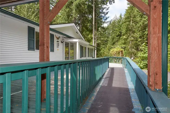 Experience easy, barrier-free living with this expansive deck, featuring a sturdy, gently sloped ramp with non-slip surfacing that ensures seamless indoor-outdoor accessibility.