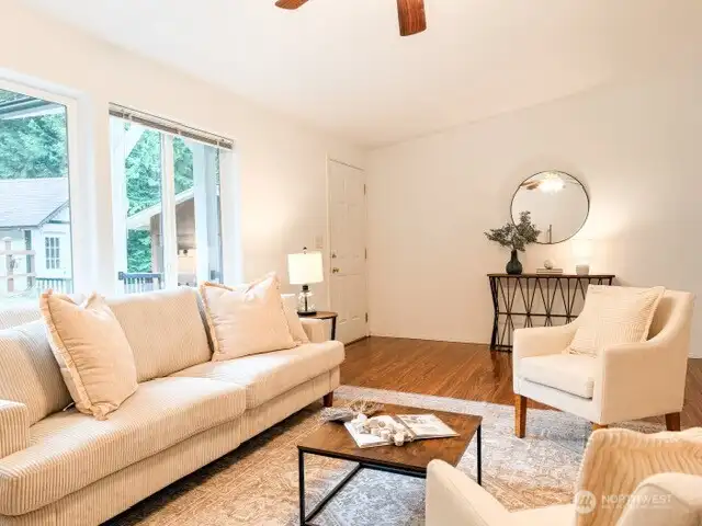 Designed for effortless entertaining and comfort, this spacious living area boasts a modern layout, pristine laminate hardwood flooring, and easy access to the deck.