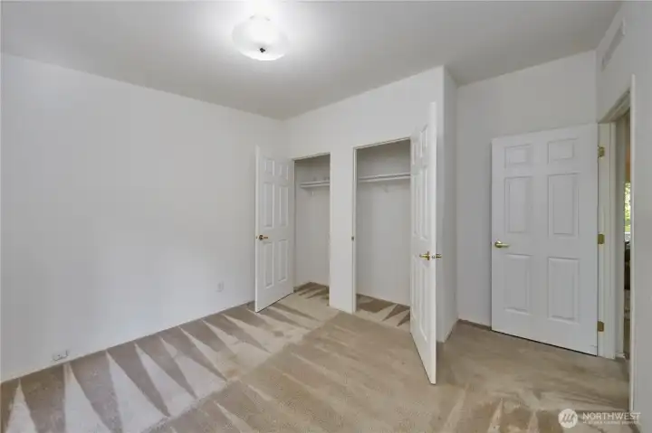 This secondary bedroom includes double closet doors, offering excellent storage capacity and easy organization.
