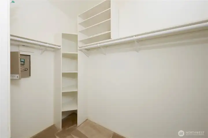 A convenient walk-in closet in the primary suite, complete with built-in shelving organizers and plenty of hanging storage space.