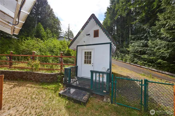 This adorable, detached cottage-style outbuilding features a private porch and entryway—perfect for a "he/she-shed," hobby studio, playhouse, or extra storage