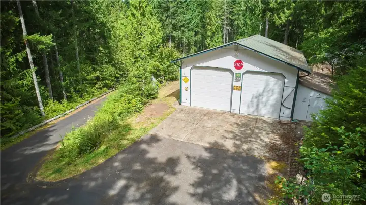 A spacious, detached two-car + RV garage with a paved apron, ideal for vehicle storage, a workshop, or keeping your outdoor recreational gear secure.