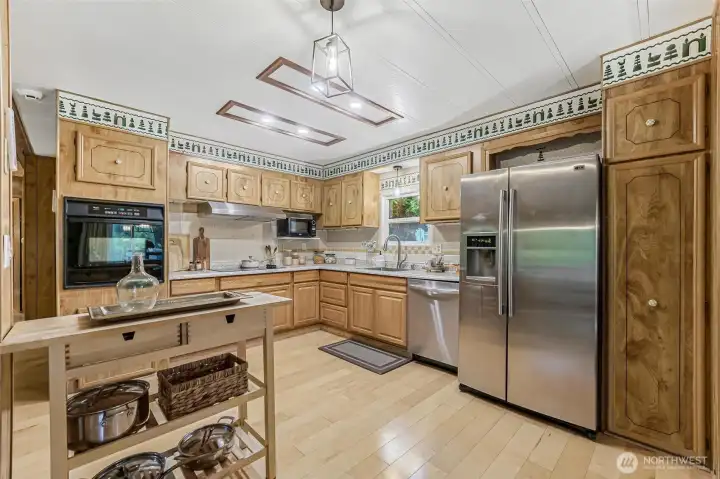 Kitchen features stainless appliances and updated lighting. Kitchen features stainless appliances and updated lighting.