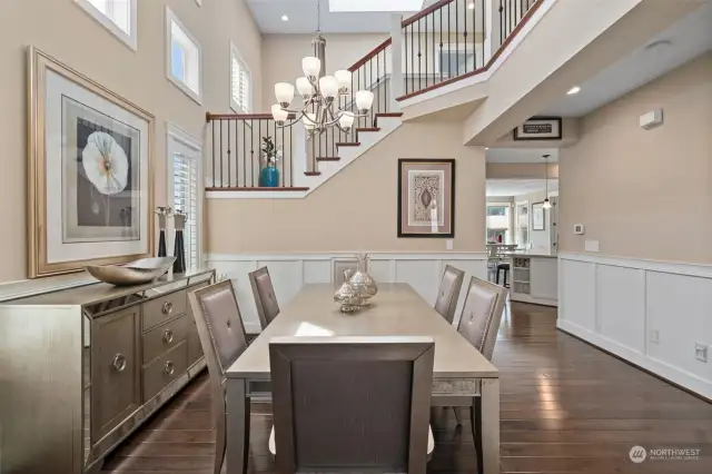 Formal Dining Room with view of two story foyer and mezzanine off of stairs.