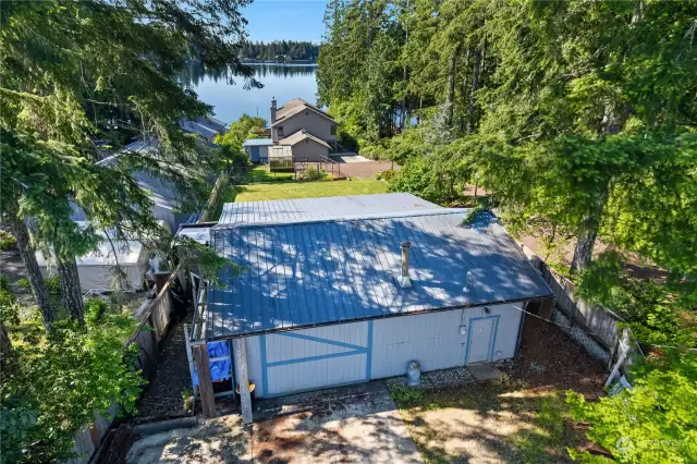 You'll enter this large parcel and pass the large work shop (aka boat storage) and take in the views of this lovely mature landscape full of flowering shrubs and trees.