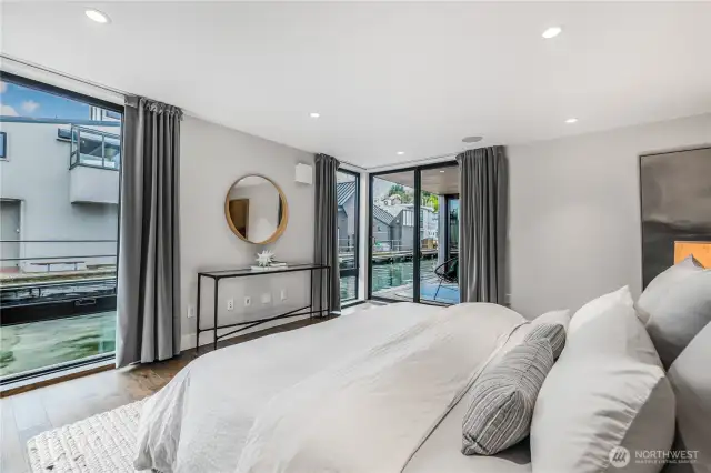 Primary suite offers two decks and luxe walk in closet.