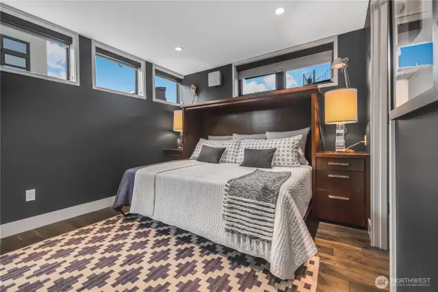 En suite main level bedroom has walk in closet and murphy bed for great guest room or convertible space.