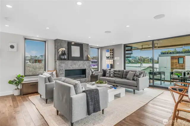 Thanks to the open floorplan, this space is perfect for entertaining or just relaxing and almost the entire front of the home opens up to the covered deck with heaters for four season living. Fireplace warms up entire house as well.