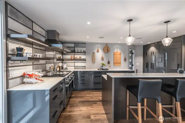 Cook's kitchen with high end Wolf range - has double convection electric ovens and gas cooking, plus flat cook tops.