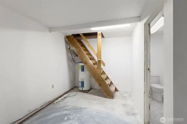 1/2 Bath in shop, stairs lead to extra storage loft.