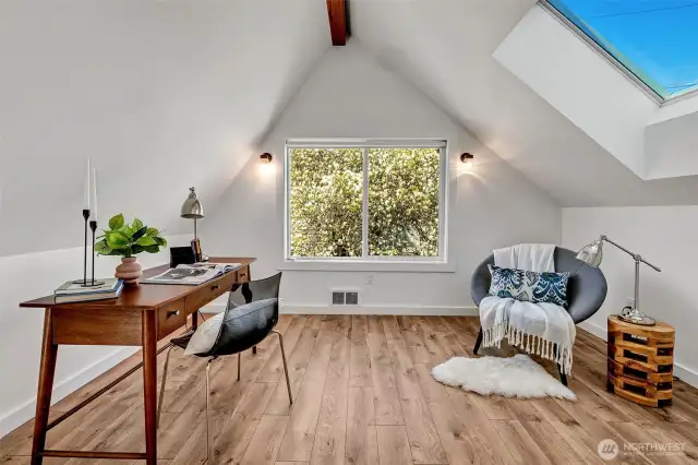 Spacious  home office with eastern exposure and skylight easily doubles as guest bedroom.